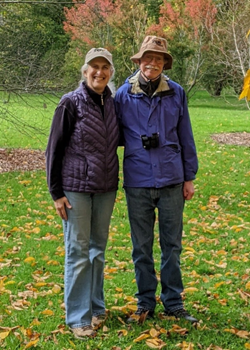 Beth and Kevin Mahar stand on a grassy field